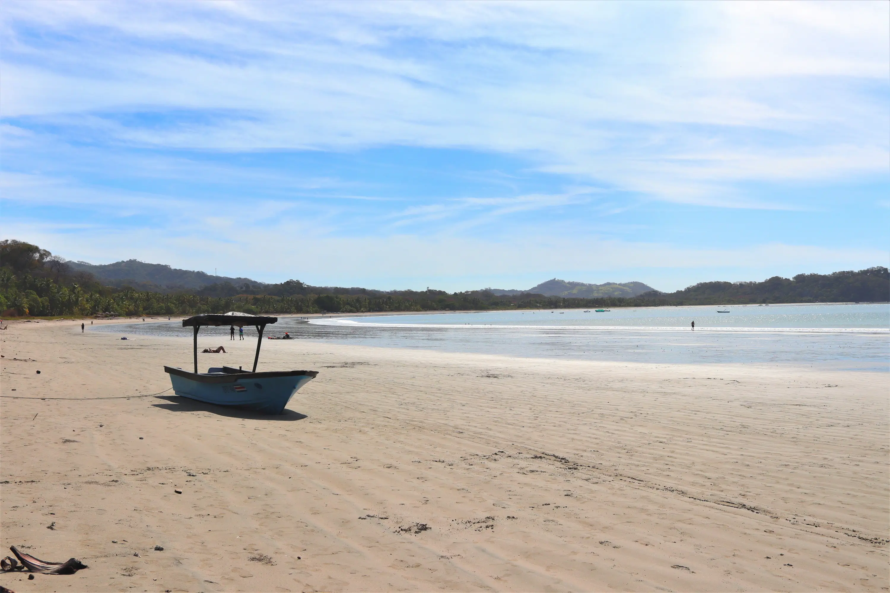 Fishing boat on a wide quiet beach in Guanacaste, Costa Rica