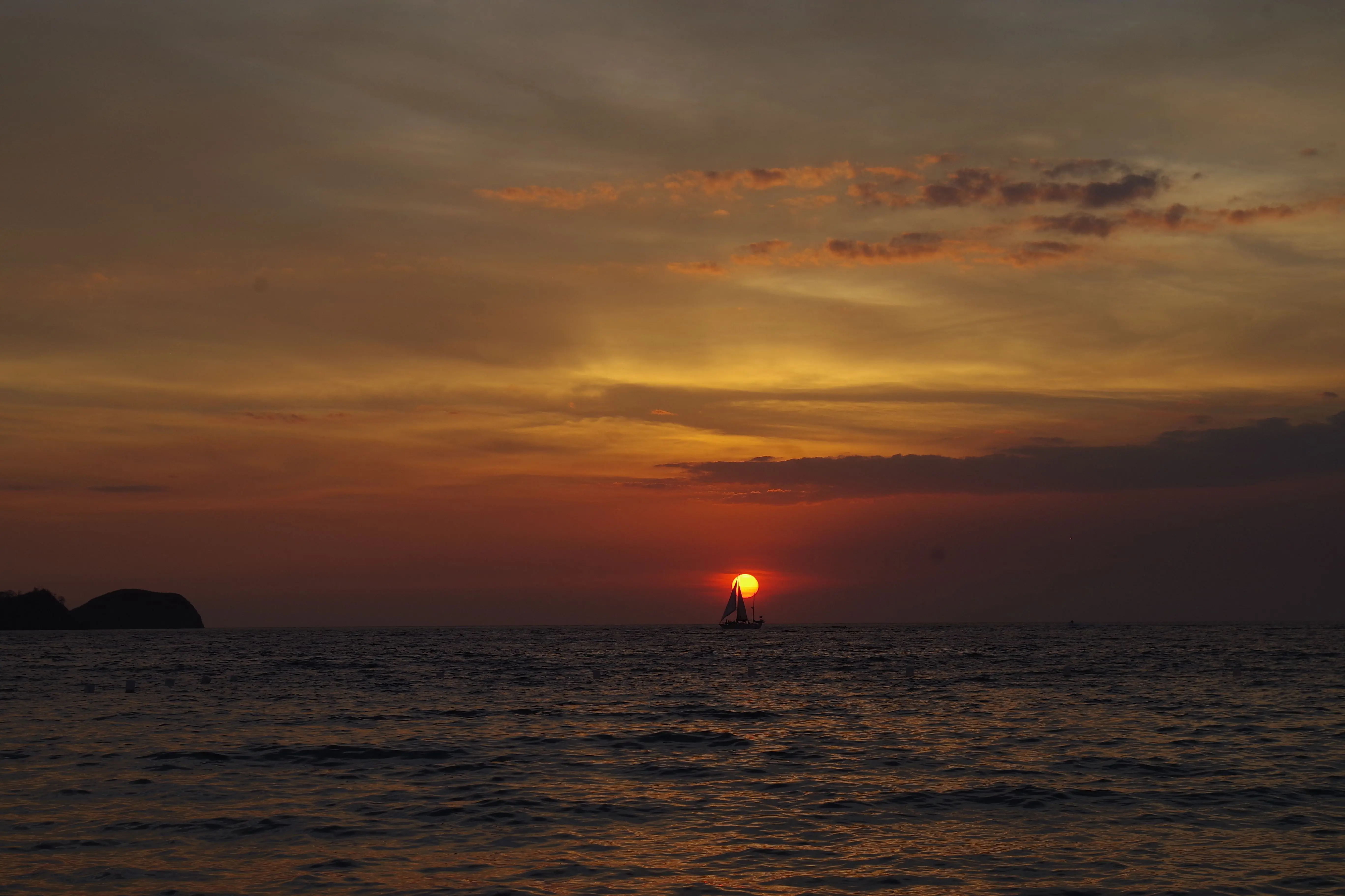 Sailboat crossing the sunset horizon off the Guanacaste coast, Costa Rica