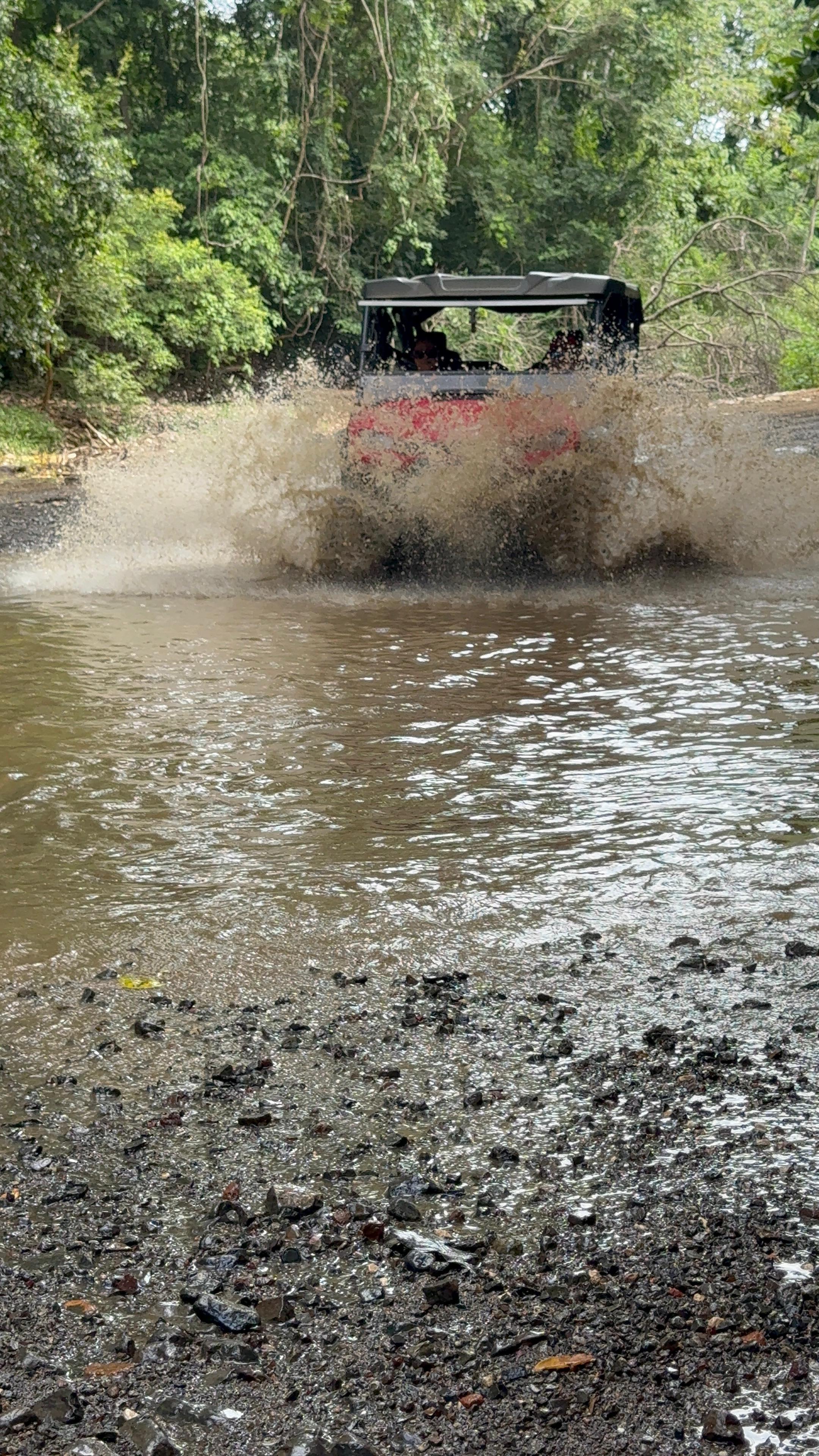 UTV kicking up mud on the trail